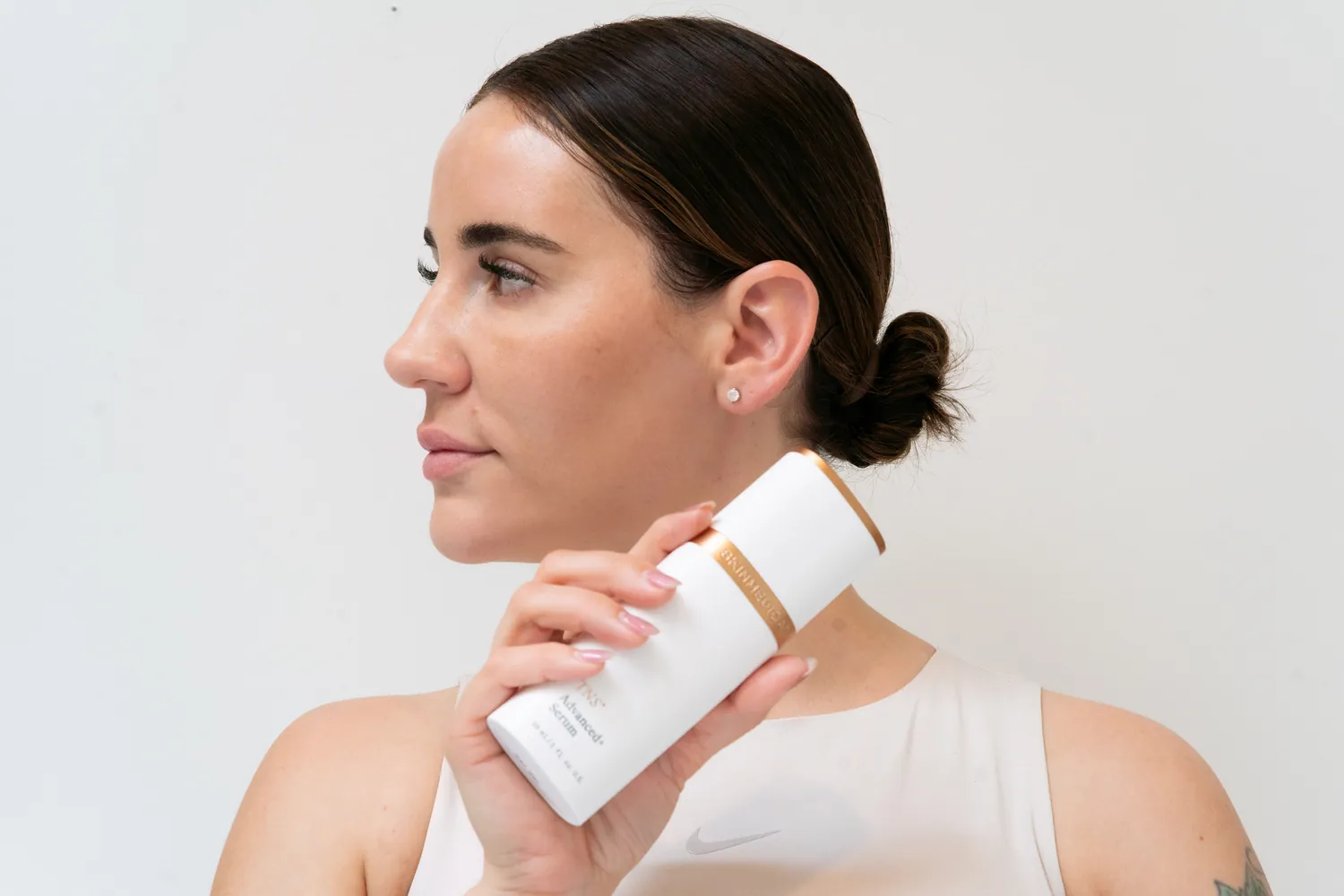 Client holding a medical-grade skincare product
